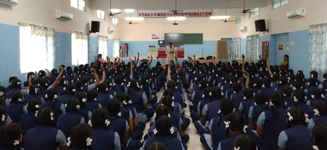 Large group of schoolgirls attending an educational awareness session organized by V V Charitable Trust in Tamil Nadu.